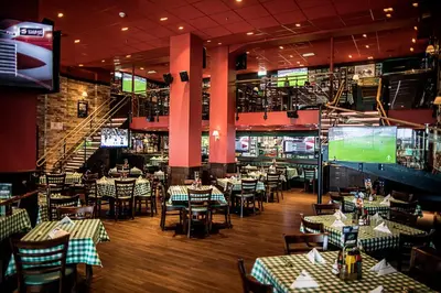 a dining room with tables and chairs and a tv at Thon Hotel Victoria Hamar in Hamar