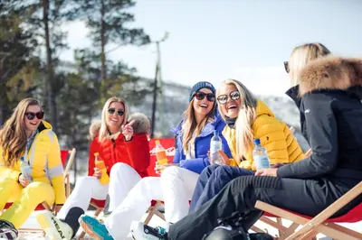 a group of women sitting in chairs in the snow at Vestlia Resort in Geilo