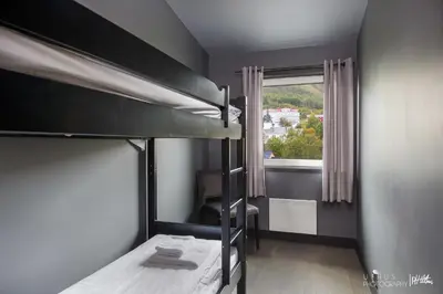 a bedroom with two bunk beds and a window at Highland Lodge in Geilo