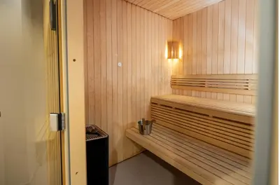 a sauna with a wooden bench in a room at Dombås Hotel in Dombås