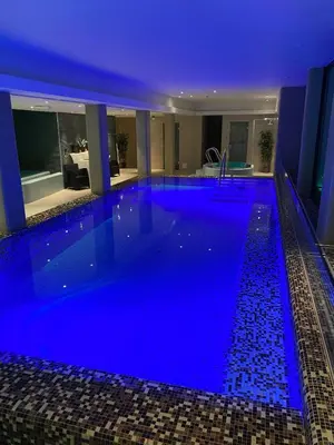 a large swimming pool with blue lighting in a hotel at Quality Hotel Strand Gjøvik in Gjøvik
