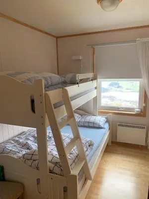 a bedroom with two bunk beds and a window at Voss Resort self-service apartments in Skulestadmo
