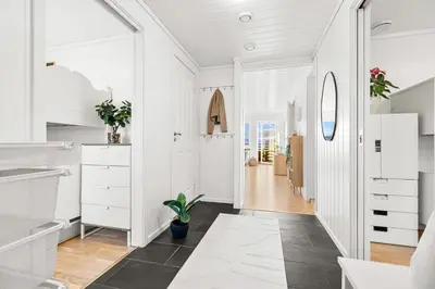 a bathroom with white cabinets and a black floor at Voss Resort self-service apartments in Skulestadmo