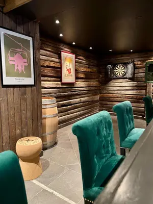 a waiting room with green chairs and a barrel at Skogstad Hotel - Unike Hoteller in Hemsedal