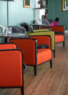 a row of chairs and tables in a room at Thon Hotel Skeikampen in Svingvoll