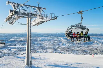 a group of people on a ski lift at Thon Hotel Skeikampen in Svingvoll