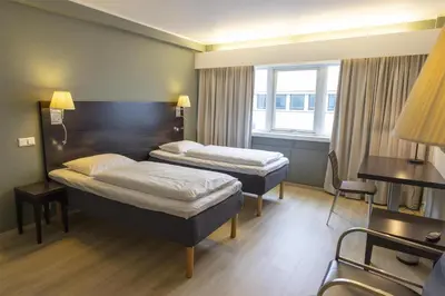 a hotel room with two beds and a window at Scandic Victoria Florø in Florø