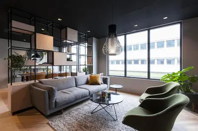 a living room with a couch and two chairs at Scandic Victoria Florø in Florø