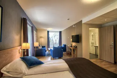 a hotel room with a bed and a bathroom at Molde Fjordhotell - by Classic Norway Hotels in Molde