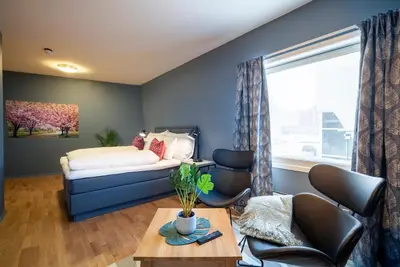 a bedroom with a bed and a table and chairs at Molde Fjordhotell - by Classic Norway Hotels in Molde