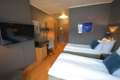 a hotel room with two beds and a flat screen tv at Trysil-Knut Hotel in Trysil