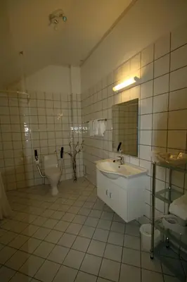 a bathroom with a sink and a toilet at Sunde Fjord Hotel, free and easy parking in Solavagen
