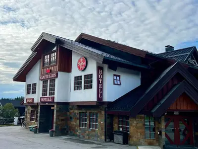 a building with a sign on the side of it at Fanitullen Hotel in Hemsedal