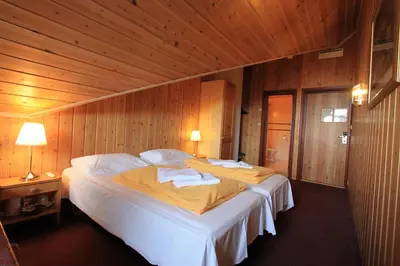 a bedroom with a large bed with two towels on it at Fanitullen Hotel in Hemsedal