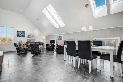 a living room with a table and chairs at Aga Fjord Apartments Hardanger in Nå