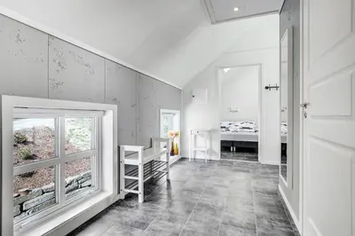 a white room with a staircase and a window at Aga Fjord Apartments Hardanger in Nå