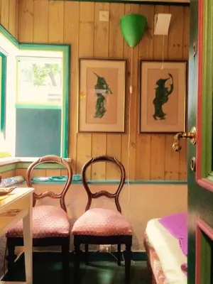 two chairs in a room with two pictures on the wall at Annehelenes B&B in Bergen