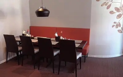 a dining room with a table and black chairs at Tynset Hotel in Tynset