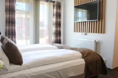 a bed in a room with a window and a television at Tynset Hotel in Tynset