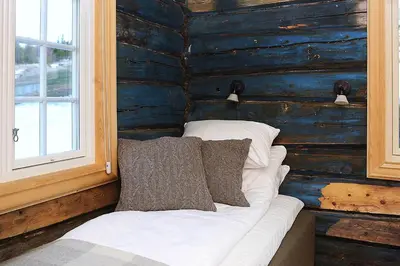 a room with a couch and pillows on a wall at Bjerkeløkkja Bed and Breakfast in Oppdal