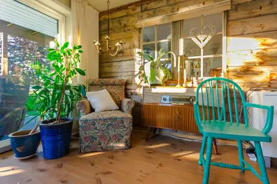 a living room with a chair and a desk and a chair at Strandheimen Guesthouse in Melhus