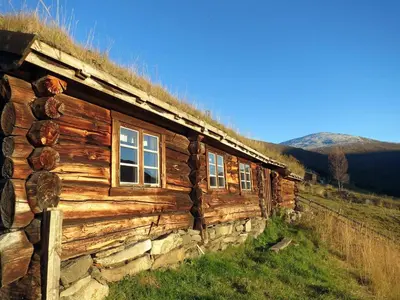 a log cabin with windows on the side of it at Strind Gard, Visdalssetra in Boverdalen