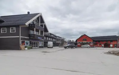 a parking lot in a town with cars and buildings at Gorgeous Apartment In Trysil With Sauna in Trysil