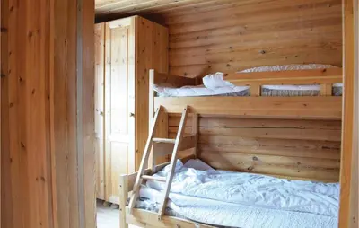 a bedroom with two bunk beds in a wooden cabin at Gorgeous Apartment In Trysil With Sauna in Trysil