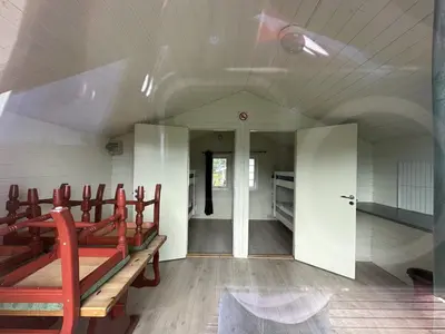 an empty church with red benches in a room at Volsdalen Camping in Ålesund
