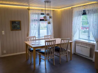 a dining room with a wooden table and chairs at Maristuen Fjellferie in Borgund