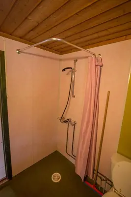 a shower in a bathroom with a pink shower curtain at Maristuen Fjellferie in Borgund