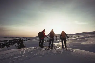 three people on skis standing on a snow covered slope at Ilsetra Hotell in Hafjell