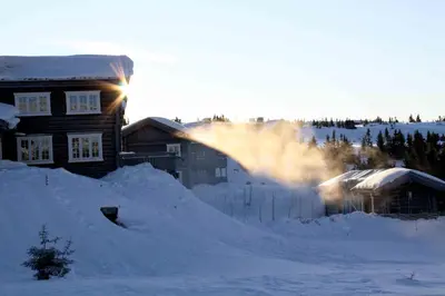 a pile of snow in front of a house at Ilsetra Hotell in Hafjell
