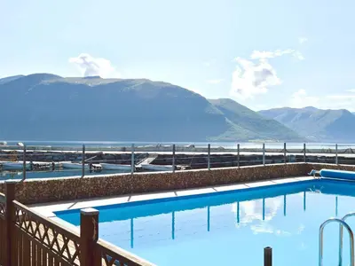 a swimming pool with a view of the water and mountains at 10 person holiday home in EIDSVÅG-By Traum in Rød