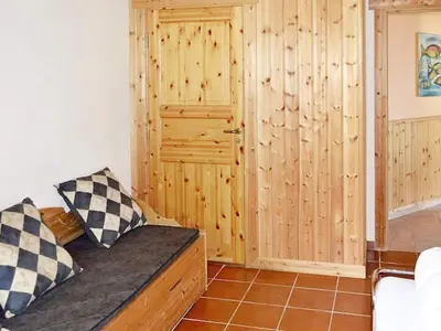 a room with a couch and a wooden wall at 10 person holiday home in EIDSVÅG-By Traum in Rød
