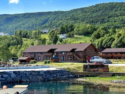 a log cabin with a marina next to a lake at 6 person holiday home in EIDSVÅG-By Traum in Rød