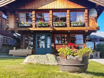 a house with potted plants in front of it at 5 person holiday home in Ringebu-By Traum in Ringebu