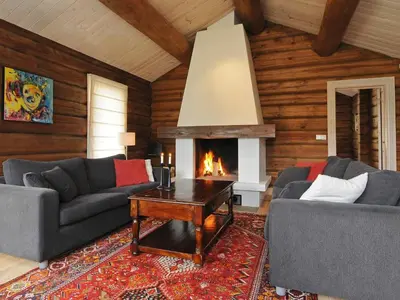 a living room with two couches and a fireplace at 12 person holiday home in Fåvang-By Traum in Favang