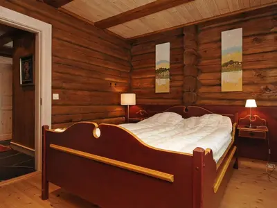 a bedroom with a bed in a room with wooden walls at 12 person holiday home in Fåvang-By Traum in Favang