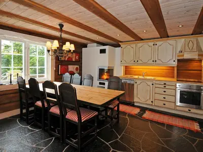 a kitchen with a wooden table and chairs at 8 person holiday home in Fåvang-By Traum in Tromsnes