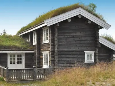 an old log house with a grass roof at 8 person holiday home in Fåvang-By Traum in Tromsnes
