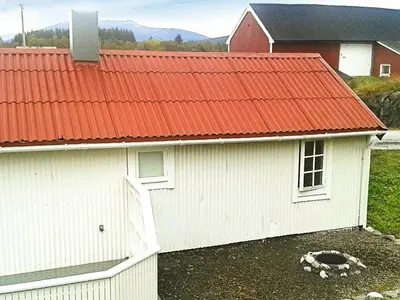 a white building with an orange roof at 4 person holiday home in VEVANG-By Traum in Vevang