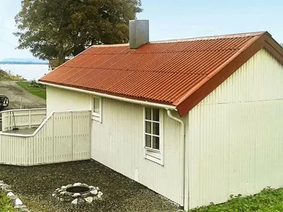 a small white building with a red roof at 4 person holiday home in VEVANG-By Traum in Vevang