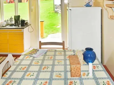 a table in a kitchen with a table cloth on it at 8 person holiday home in Liabygda-By Traum in Eidsdal