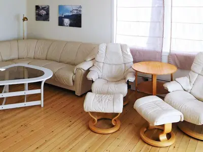 a living room with a couch and chairs and a table at 8 person holiday home in Sørbøvåg in Sørbø