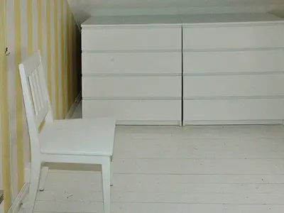 a white chair in a room with a dresser at 8 person holiday home in Sørbøvåg in Sørbø