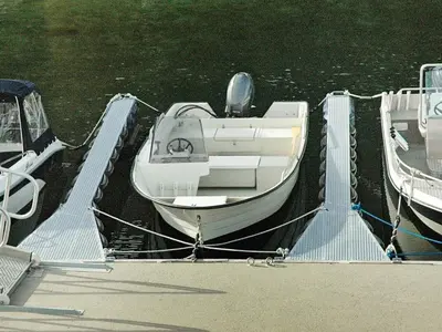 a boat is docked at a dock in the water at 8 person holiday home in Sørbøvåg in Sørbø