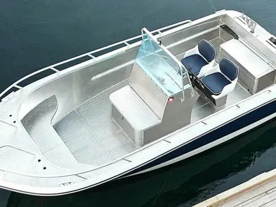 a white boat with seats on the water at 8 person holiday home in Sørbøvåg in Sørbø
