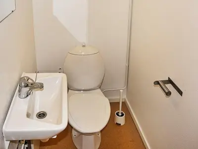 a small bathroom with a toilet and a sink at 12 person holiday home in Oksvoll in Oksvoll