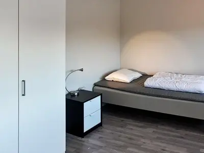a bedroom with a bed and a nightstand with a bed sidx sidx sidx sidx at 12 person holiday home in Oksvoll in Oksvoll